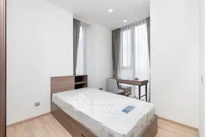 Modern minimalist bedroom with large windows and sleek furniture