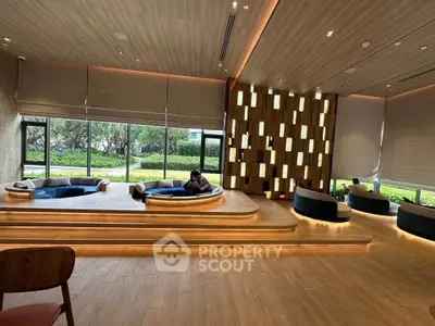 Luxurious modern living room with unique seating and large windows overlooking a garden.