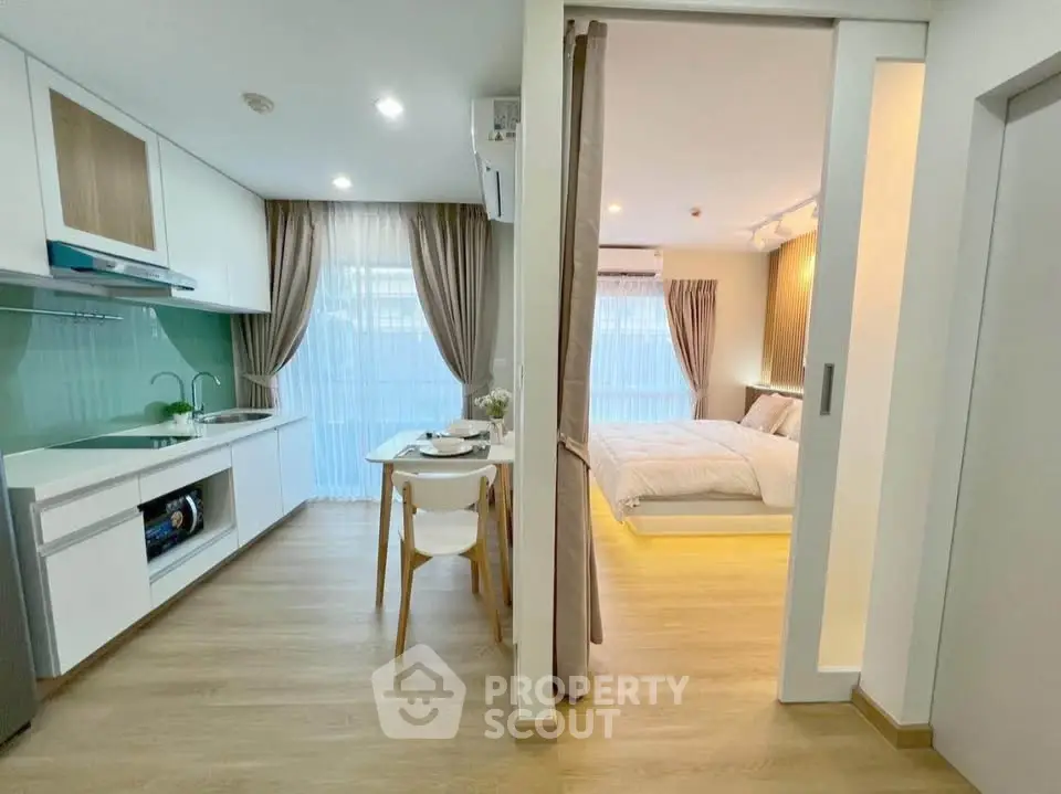 Modern open-plan kitchen and bedroom with stylish decor and natural light.