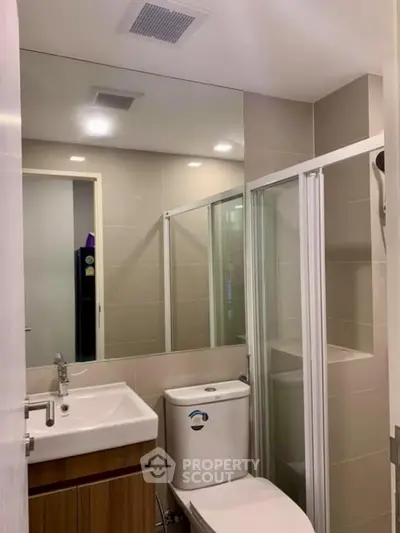 Modern bathroom with sleek fixtures and glass shower enclosure