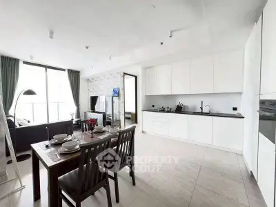 Spacious modern kitchen with open layout and dining area in bright apartment.