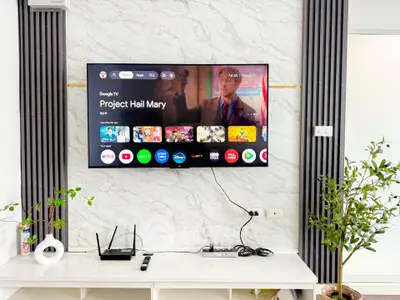 Modern living room with wall-mounted TV and sleek entertainment setup