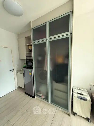 Modern apartment interior with compact kitchen and storage solutions