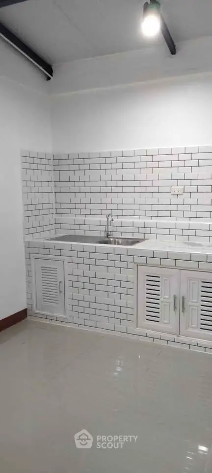 Modern kitchen with white subway tiles and sleek cabinetry