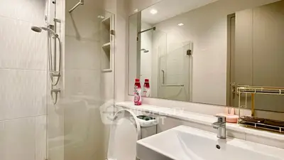 Modern bathroom with sleek fixtures and glass shower enclosure