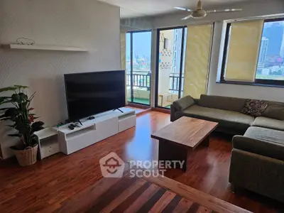 Spacious living room with modern decor and city view balcony