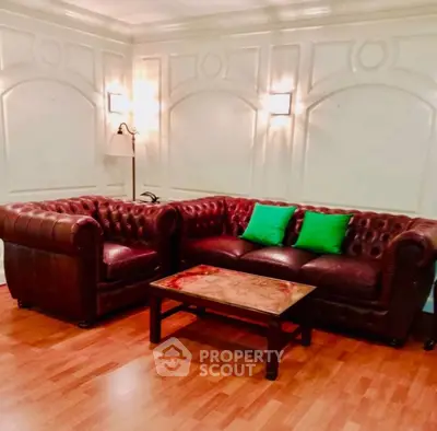 Elegant living room with classic leather sofas and stylish lighting