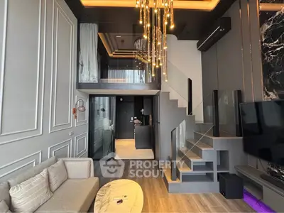 Luxurious modern living room with high ceilings and elegant chandelier