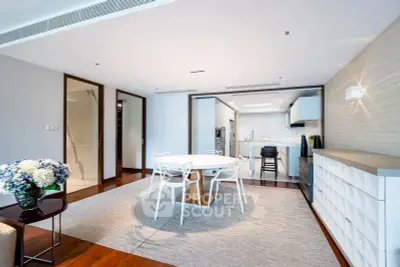 Modern open-plan living and dining area with sleek kitchen design.