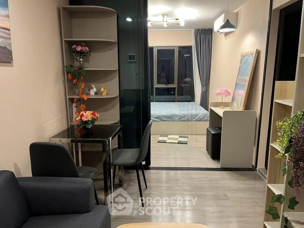 Modern studio apartment with stylish decor and open layout, featuring a cozy living area and bedroom.