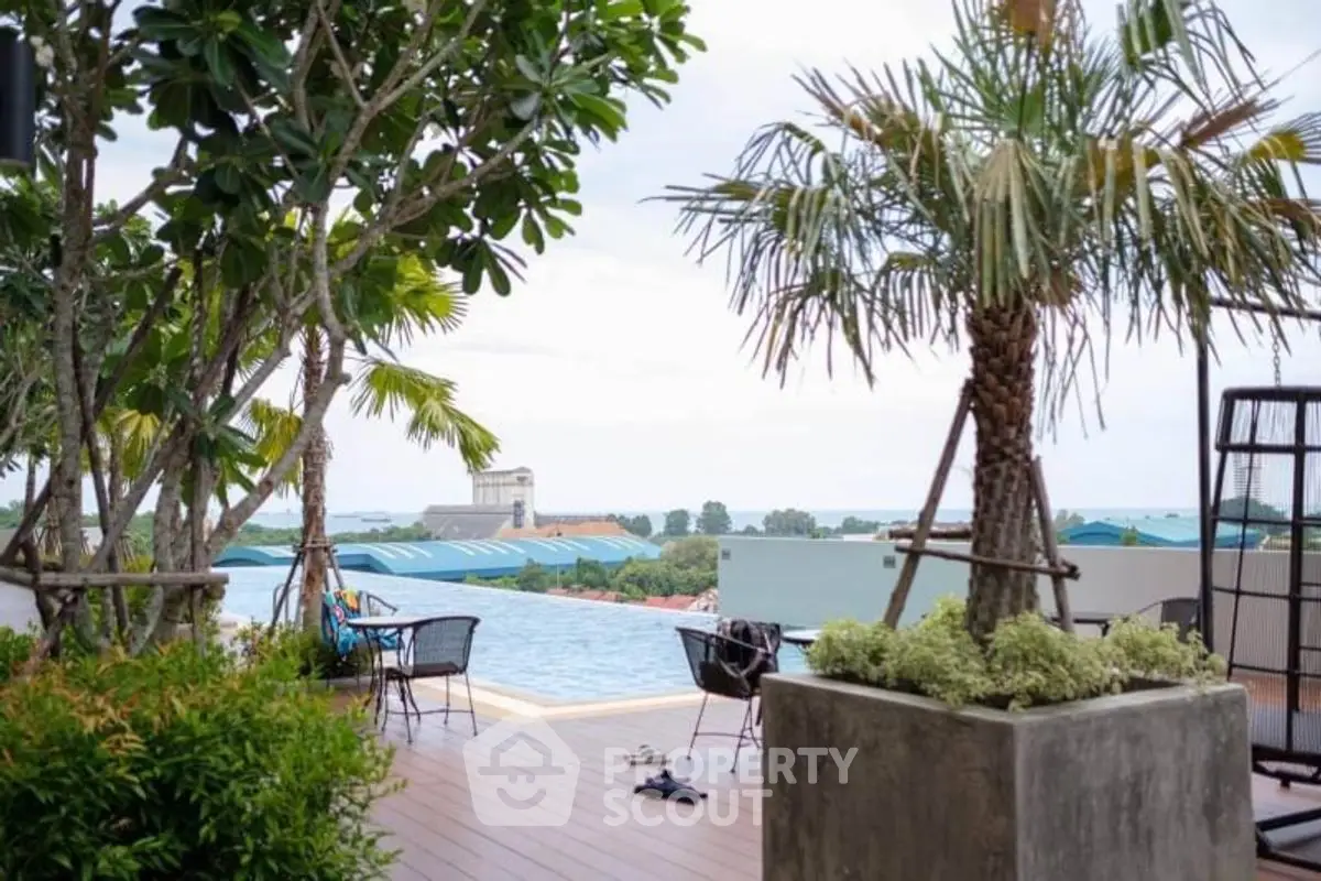 Luxurious rooftop pool area with stunning views and lush greenery.