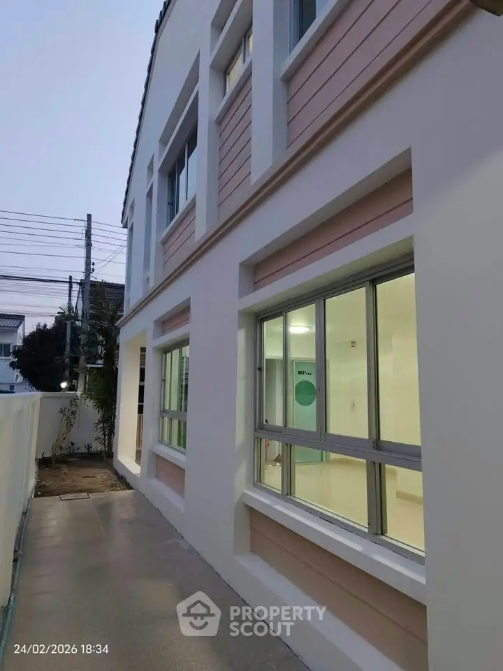 Modern two-story building exterior with large windows and clean design