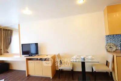 Modern living room with TV, dining area, and stylish decor