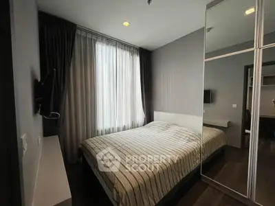 Cozy bedroom with modern decor and large mirrored wardrobe