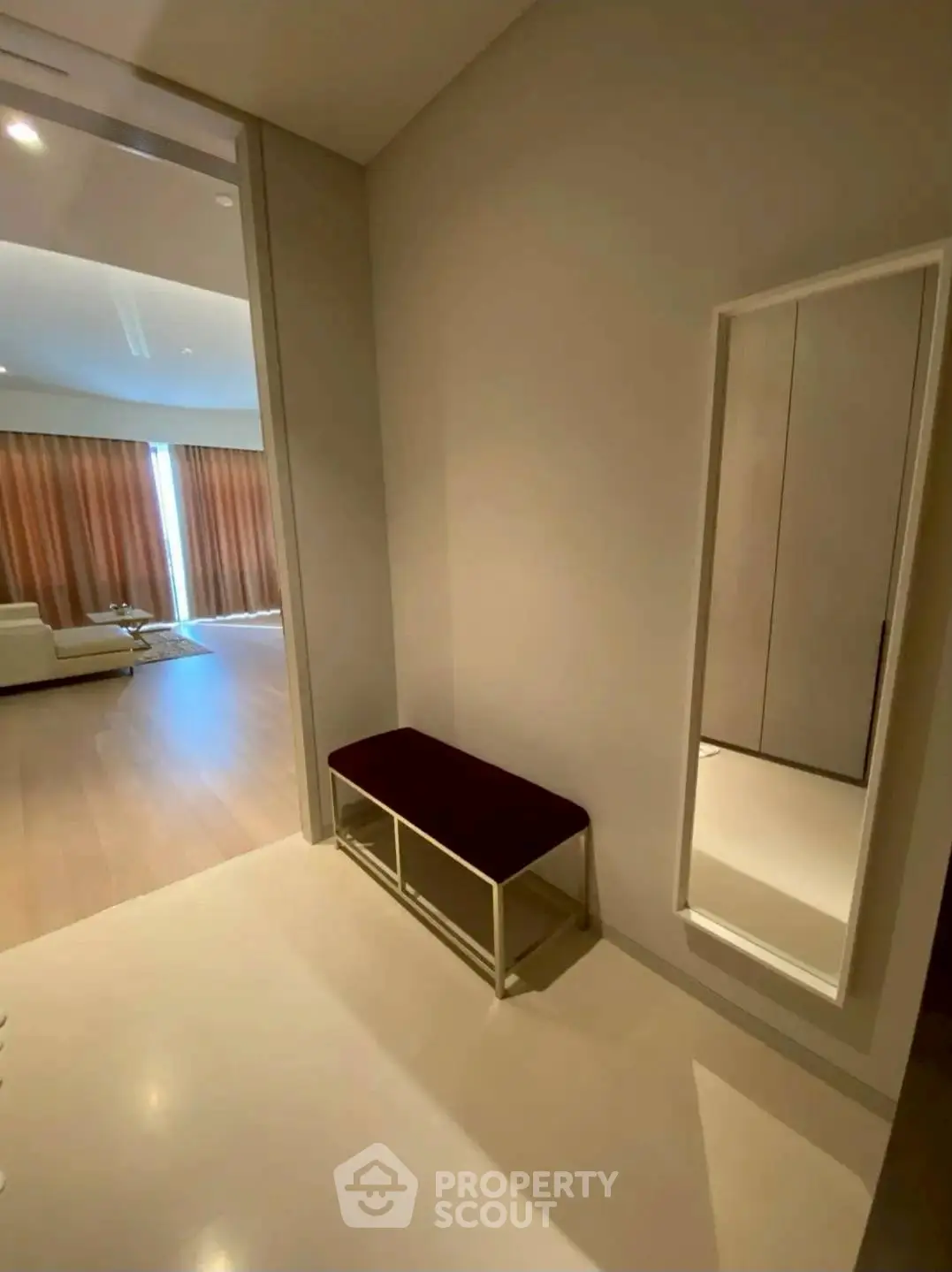 Spacious modern living area with stylish bench and full-length mirror
