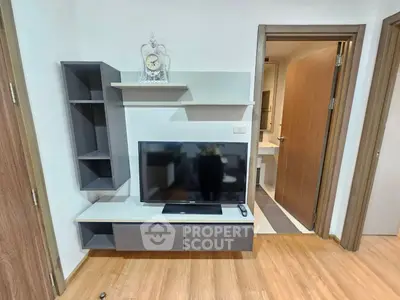 Modern living room with sleek TV unit and wooden flooring