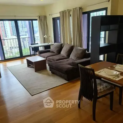 Spacious living room with modern furniture and city view, perfect for urban living.
