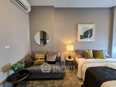 Modern bedroom with stylish decor, cozy seating area, and elegant lighting.