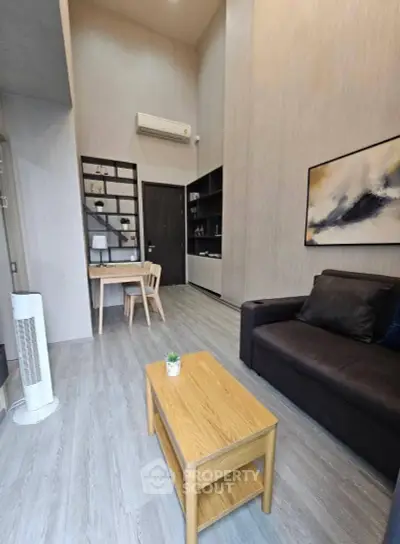 Modern living room with high ceiling, stylish furniture, and elegant decor in a contemporary apartment.