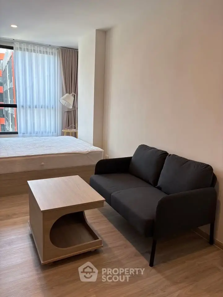 Modern studio apartment with cozy living area and natural light