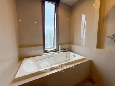Luxurious bathroom with a city view and elegant bathtub, perfect for relaxation.