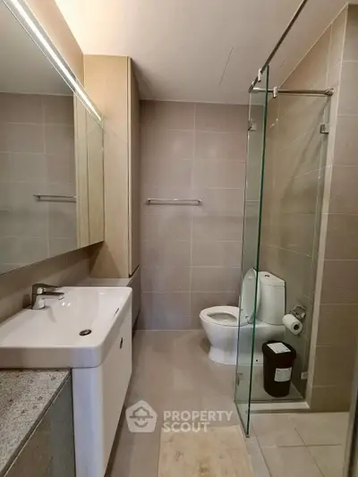 Modern bathroom with glass shower and sleek fixtures