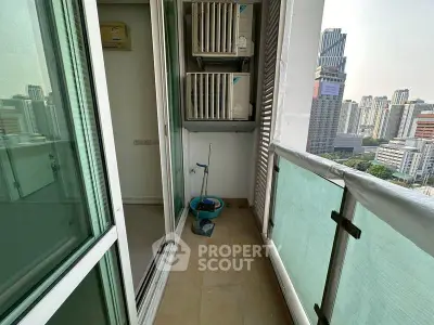 High-rise balcony with city view and air conditioning units, perfect for urban living.