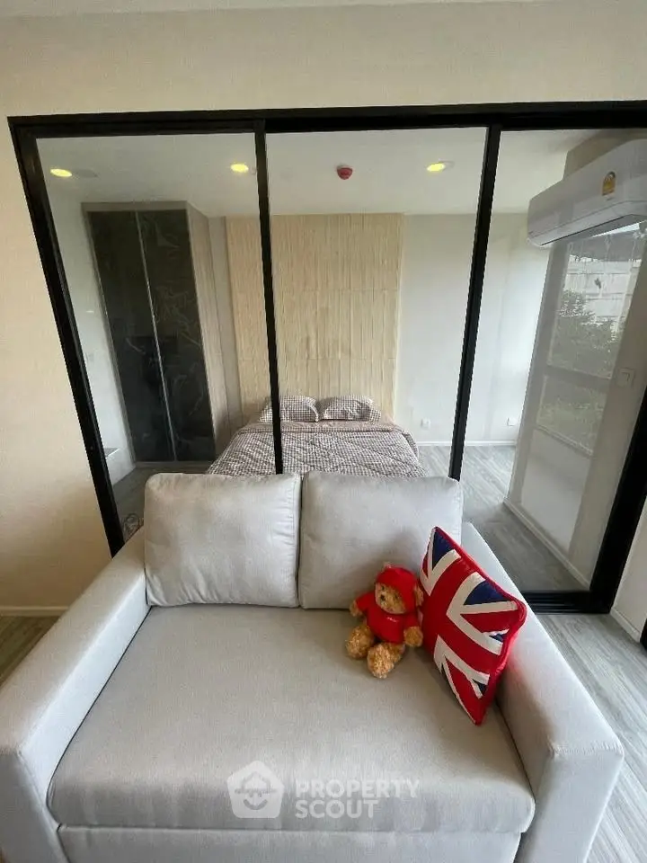 Modern studio apartment with glass partition and cozy decor