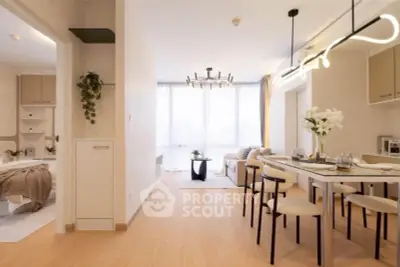 Modern open-plan living and dining area with stylish lighting and cozy decor.