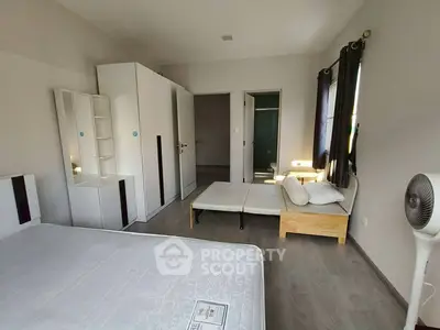 Spacious bedroom with modern furniture and natural light