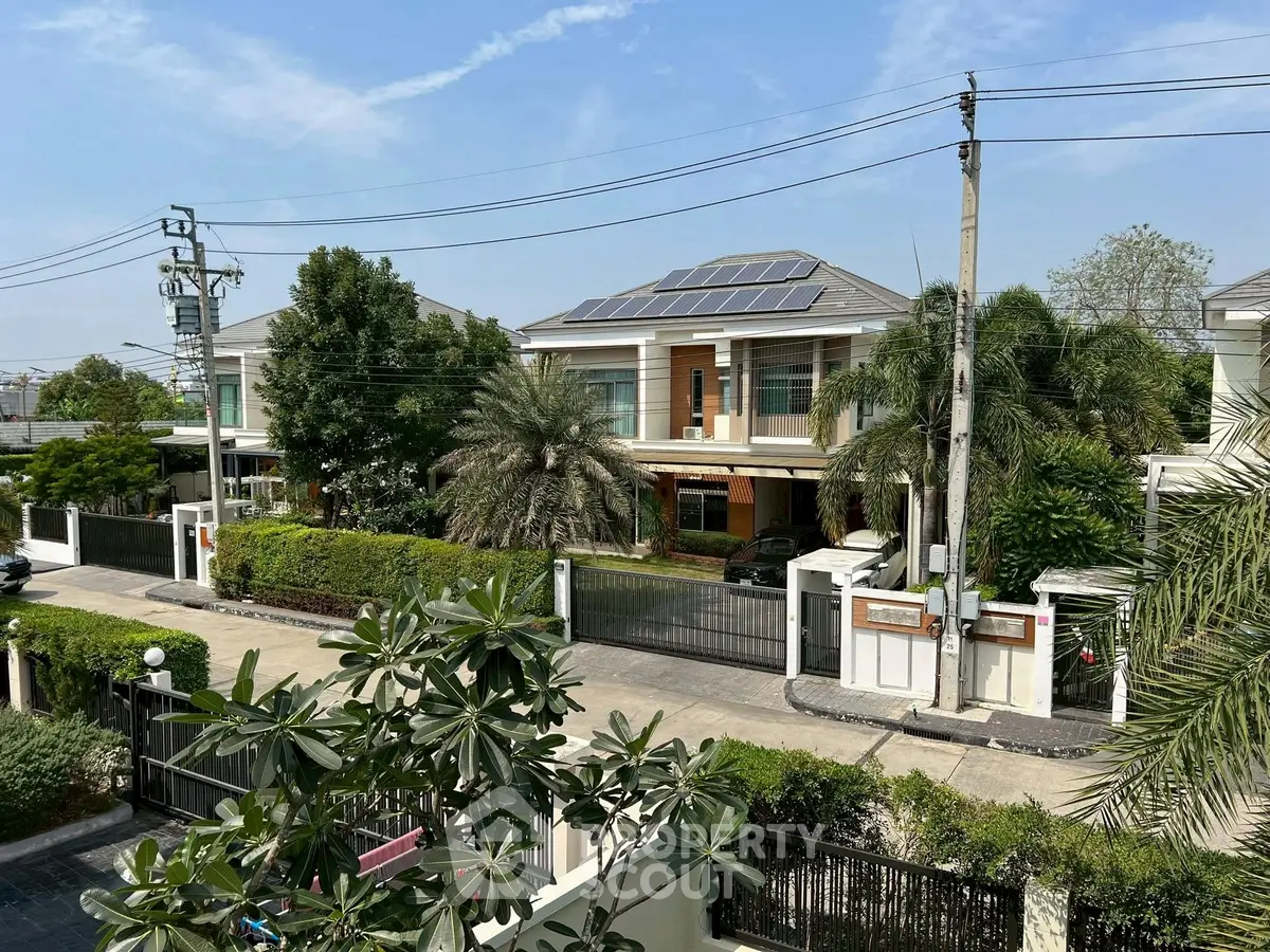 Luxurious suburban homes with solar panels and lush greenery