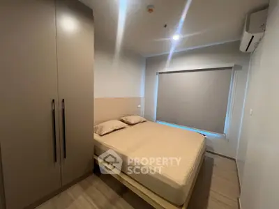 Cozy modern bedroom with sleek wardrobe and air conditioning