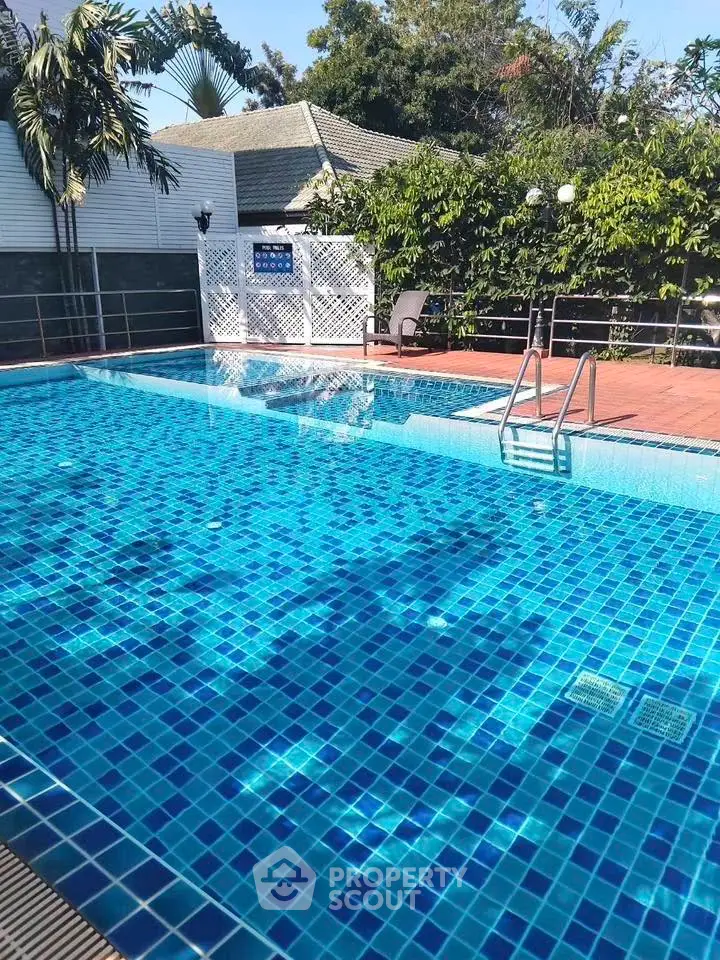 Stunning outdoor pool area with lush greenery and serene ambiance, perfect for relaxation and leisure.
