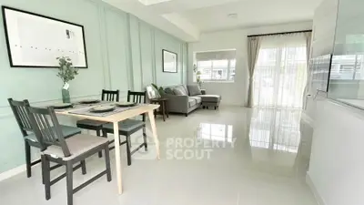 Spacious living room with elegant dining area and natural light