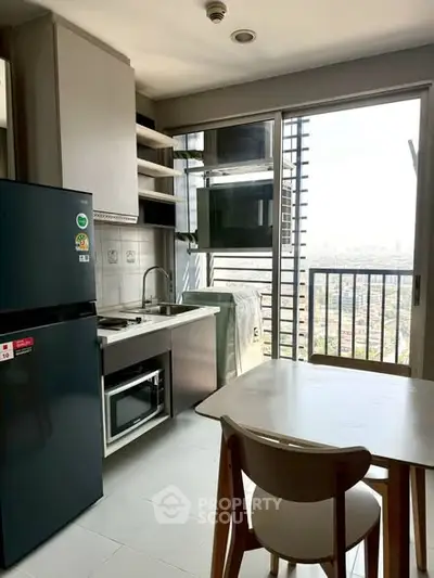 Modern kitchen with open layout and city view from balcony