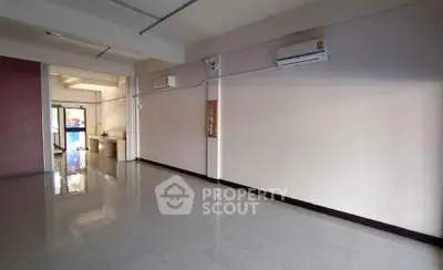 Spacious empty room with air conditioning and glossy tiled floor, ideal for customization.