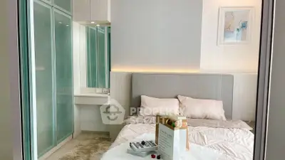 Modern bedroom with stylish decor and soft lighting, featuring a cozy bed and sleek wardrobe.