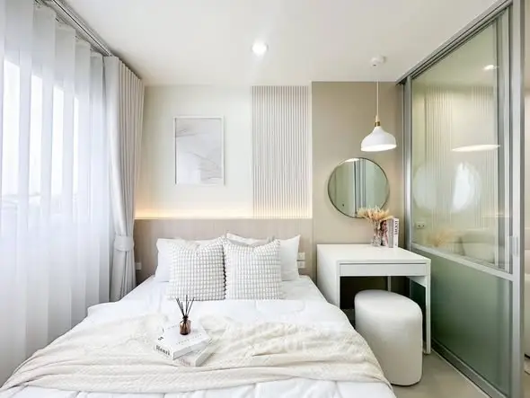Modern bedroom with elegant decor, featuring a cozy bed, stylish vanity, and soft lighting for a serene ambiance.