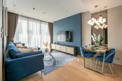 Elegant modern living room with blue accents, stylish furniture, and natural light.