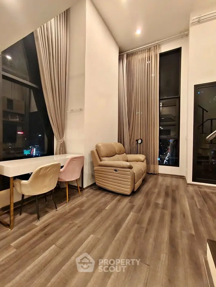 Luxurious high-ceiling living room with elegant decor and city view