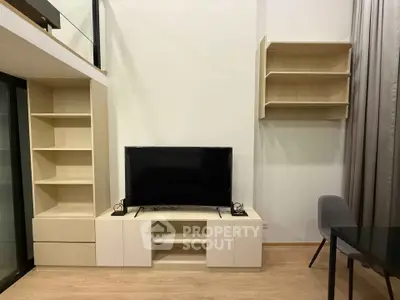 Modern living room with sleek TV unit and stylish shelving in a contemporary apartment.