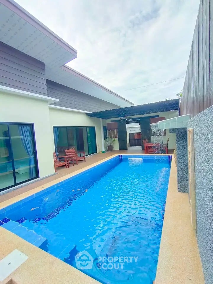 Luxurious modern home with private pool and stylish outdoor seating area, perfect for relaxation and entertainment.