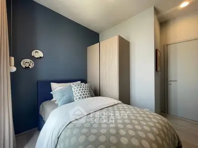 Cozy modern bedroom with stylish decor and ample natural light
