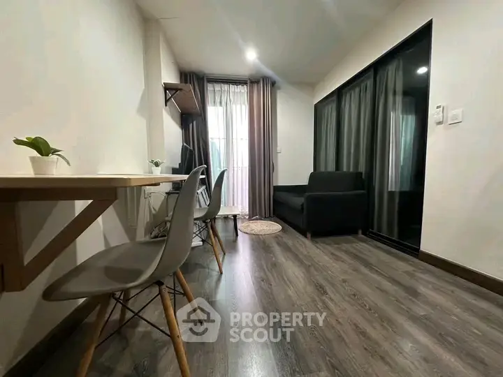 Modern living room with sleek flooring and stylish furniture in a cozy apartment.