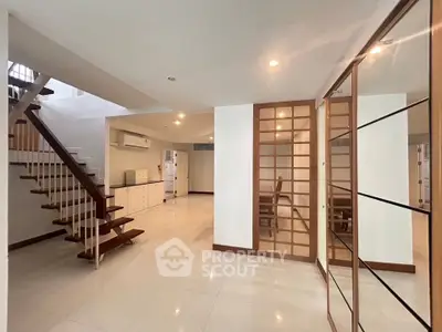 Spacious modern interior with elegant staircase and open layout, perfect for stylish living.