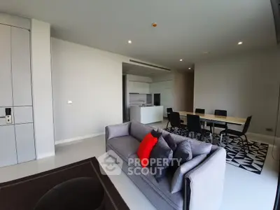 Modern living room with stylish furniture and open kitchen layout in a contemporary apartment.