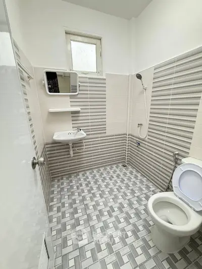 Modern bathroom with stylish tile design and compact fixtures