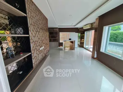 Spacious modern living room with elegant design and large windows offering natural light.