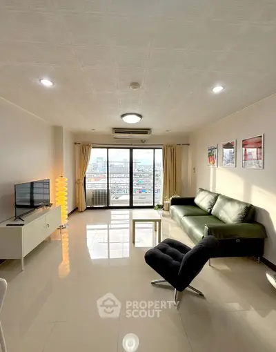 Spacious living room with modern furniture and city view balcony