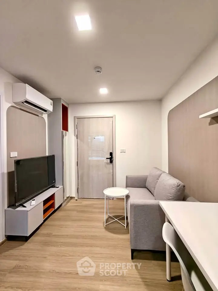 Modern living room with sleek furniture and air conditioning in a stylish apartment.